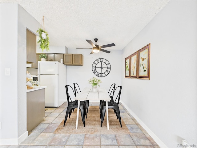 190 E Highline Cir Unit 302, Centennial, CO 80122 - dining room with a ceiling fan, a textured ceiling, and baseboards