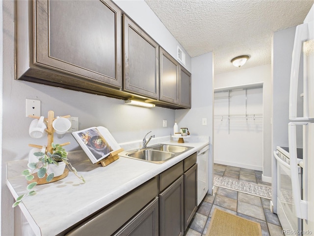 190 E Highline Cir Unit 302, Centennial, CO 80122 - kitchen featuring a sink, light stone finish flooring, white appliances, light countertops, and a textured ceiling