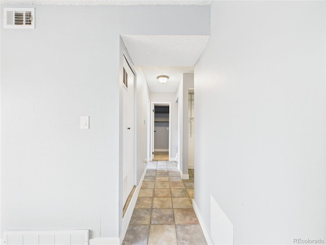 190 E Highline Cir Unit 302, Centennial, CO 80122 - hallway featuring baseboards and light stone finish flooring