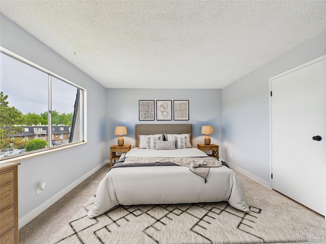 190 E Highline Cir Unit 302, Centennial, CO 80122 - bedroom with carpet floors, a textured ceiling, and baseboards