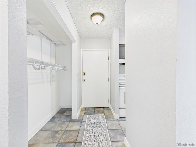 190 E Highline Cir Unit 302, Centennial, CO 80122 - entryway featuring baseboards, a textured ceiling, and stone finish floors