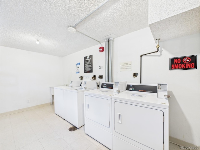 190 E Highline Cir Unit 302, Centennial, CO 80122 - communal laundry room with independent washer and dryer, a textured ceiling, and baseboards