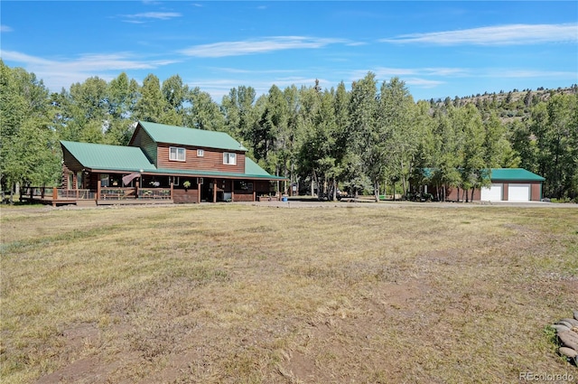 exterior space featuring a wooden deck, a garage, and an outdoor structure