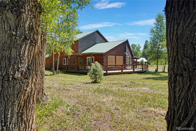 exterior space featuring a wooden deck and a yard