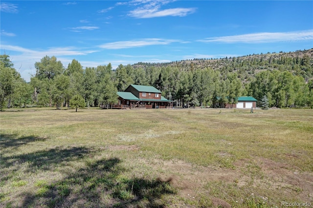 view of yard with a rural view and an outdoor structure