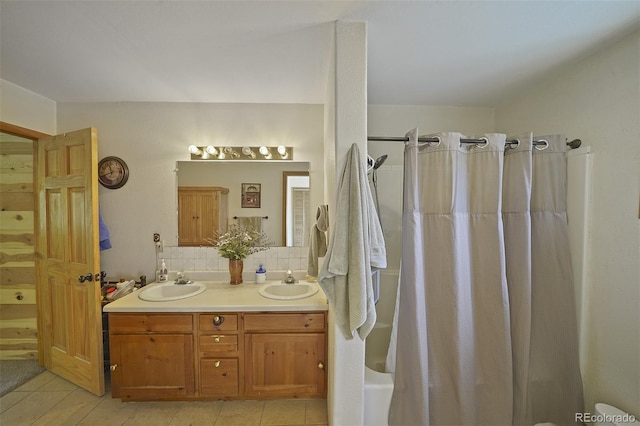 bathroom with vanity, tile patterned flooring, shower / bathtub combination with curtain, and decorative backsplash