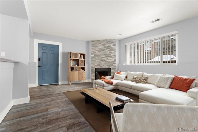 living room featuring dark hardwood / wood-style floors and a fireplace