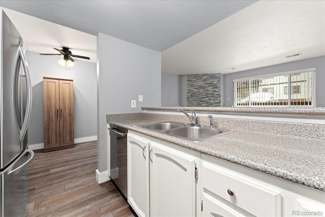 kitchen featuring sink, white cabinetry, appliances with stainless steel finishes, ceiling fan, and light hardwood / wood-style floors