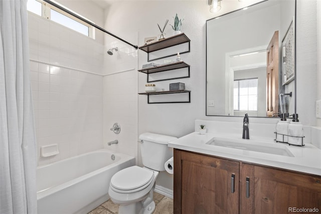 bathroom featuring a healthy amount of sunlight, toilet, shower / bath combo with shower curtain, and vanity