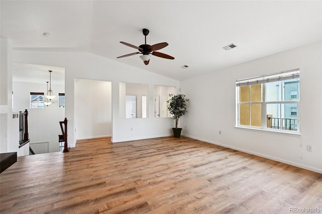 unfurnished living room featuring visible vents, ceiling fan, vaulted ceiling, and wood finished floors