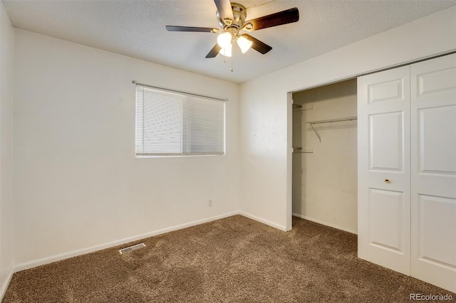unfurnished bedroom featuring carpet flooring, baseboards, a closet, and a textured ceiling