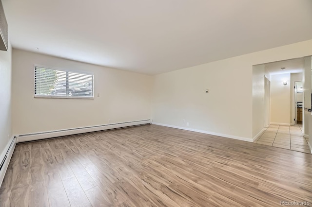 5995 W Hampden Ave Unit 2G, Denver, CO 80227 - empty room featuring light wood-type flooring, baseboards, and baseboard heating