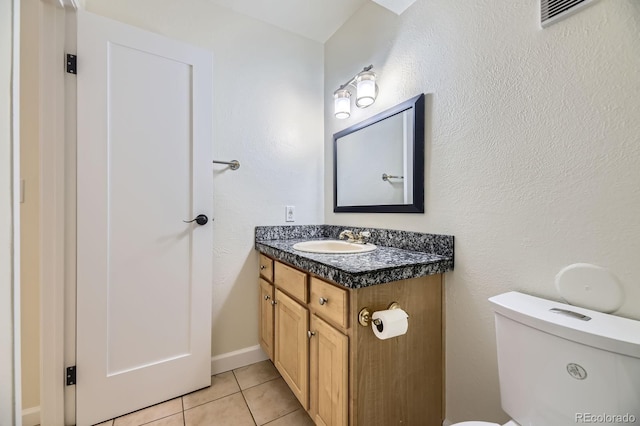 5995 W Hampden Ave Unit 2G, Denver, CO 80227 - bathroom featuring vanity, tile patterned flooring, and toilet