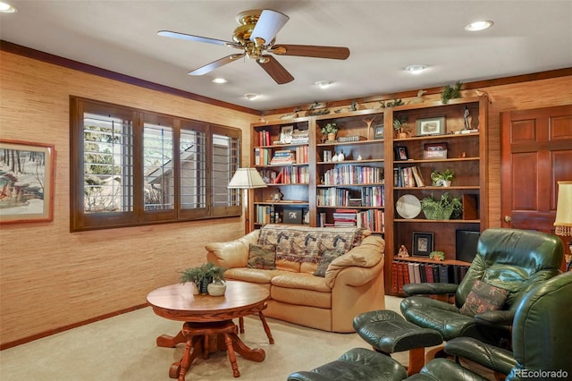 living area with ceiling fan and light carpet