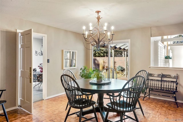 dining space with a notable chandelier and light parquet flooring