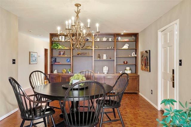 dining area with parquet floors and a chandelier