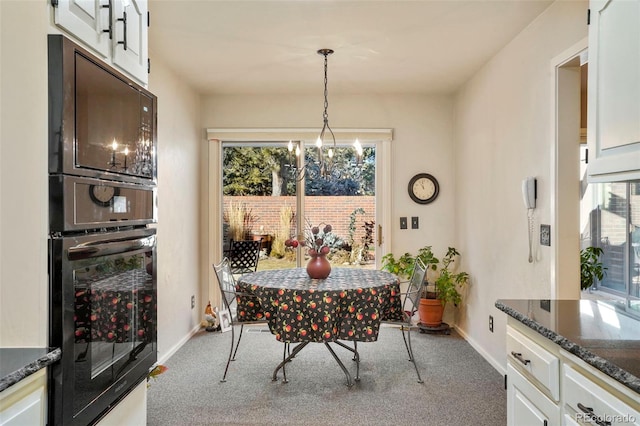 dining space with a wealth of natural light, light carpet, and an inviting chandelier