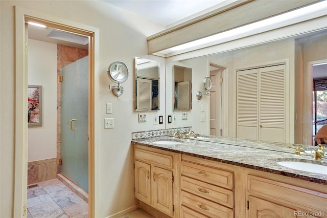 bathroom with vanity and a shower with door