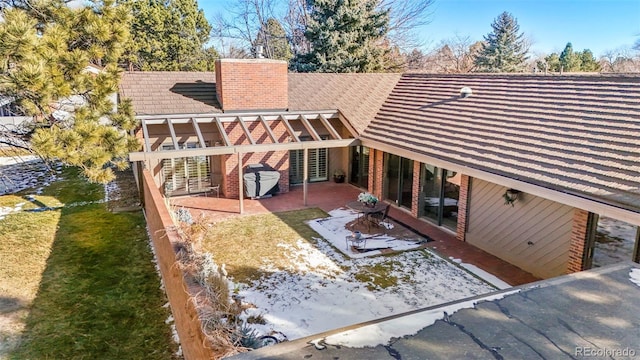 back of house with a patio and a lawn