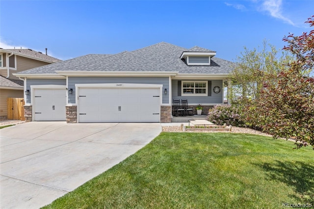 view of front of property with a garage, driveway, a front yard, stone siding, and roof with shingles
