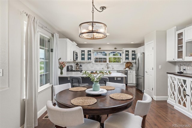 dining room with a chandelier, baseboards, dark wood-style floors, and recessed lighting