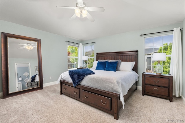 bedroom featuring light carpet, baseboards, and ceiling fan