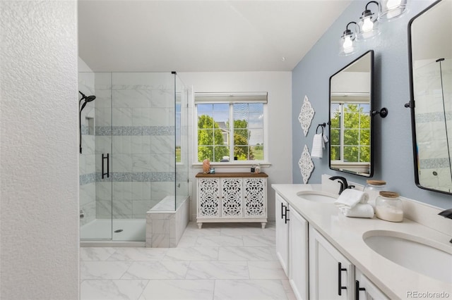 bathroom with marble finish flooring, a shower stall, double vanity, and lofted ceiling