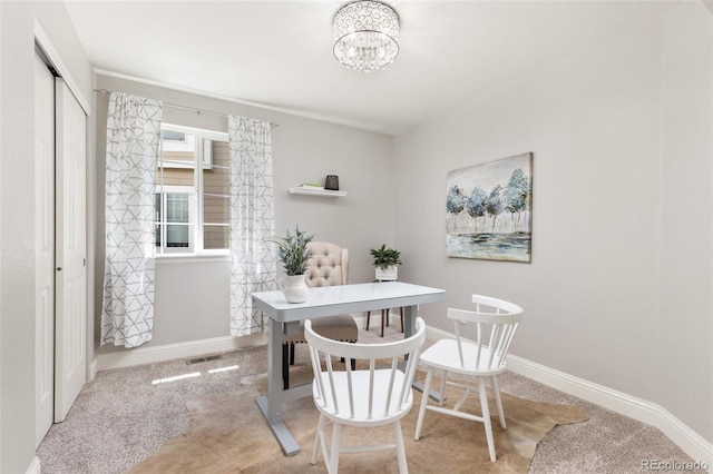 dining space with carpet flooring, a chandelier, baseboards, and an office area