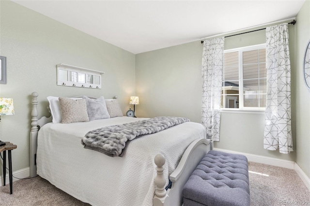 bedroom with carpet and baseboards