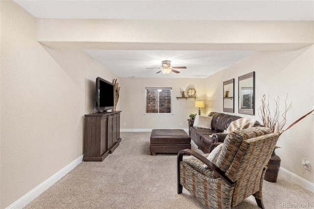living room featuring ceiling fan, light colored carpet, and baseboards