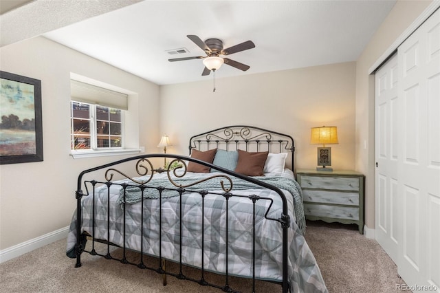 carpeted bedroom featuring a closet, baseboards, and ceiling fan