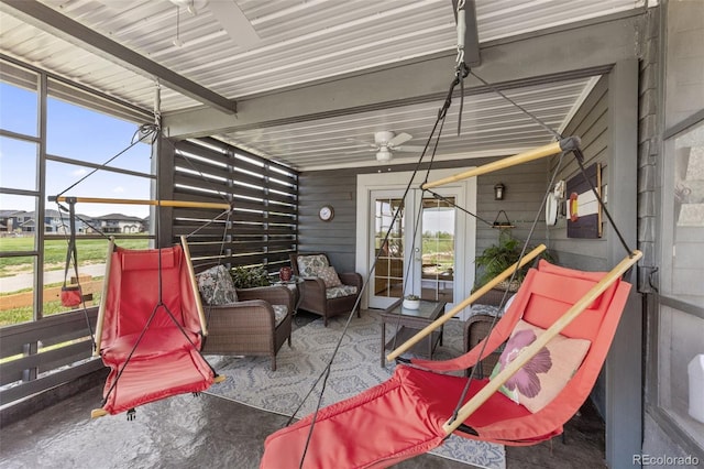 sunroom with ceiling fan, an outdoor living space, and plenty of natural light