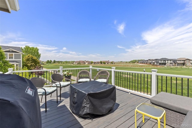 deck with a grill and a lawn