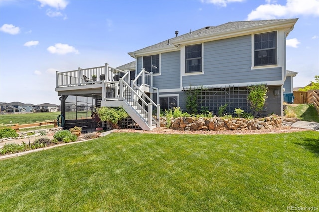 back of house with stairs, a lawn, and a wooden deck