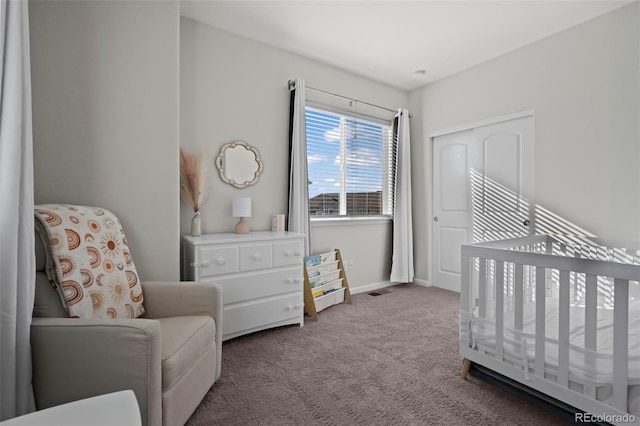 bedroom featuring carpet flooring and a crib