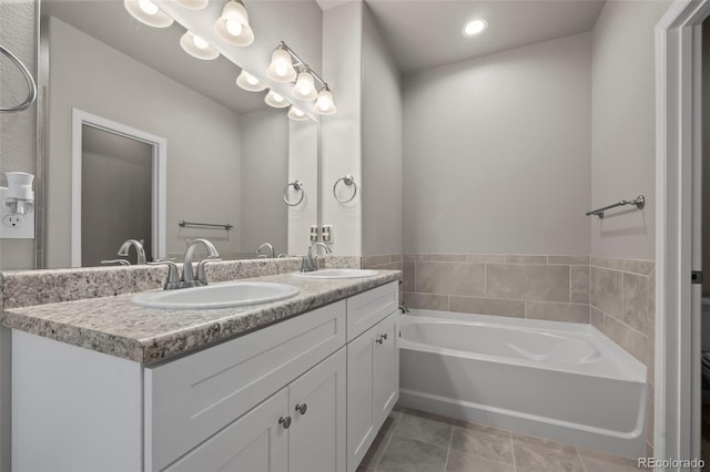 bathroom featuring a washtub, tile patterned flooring, and vanity