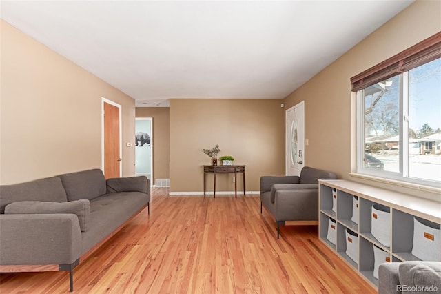 living area featuring light wood-type flooring and baseboards