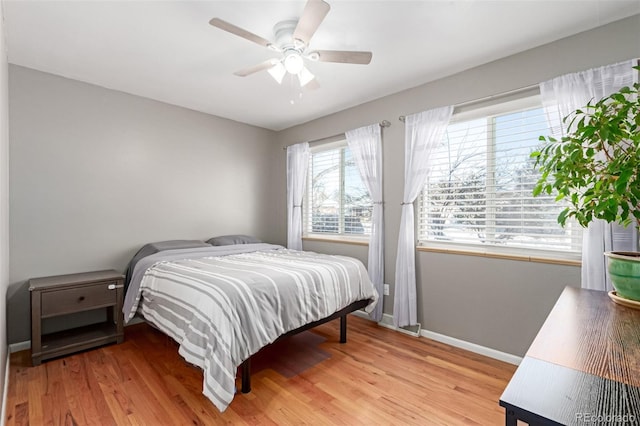 bedroom featuring light wood-type flooring, ceiling fan, and baseboards