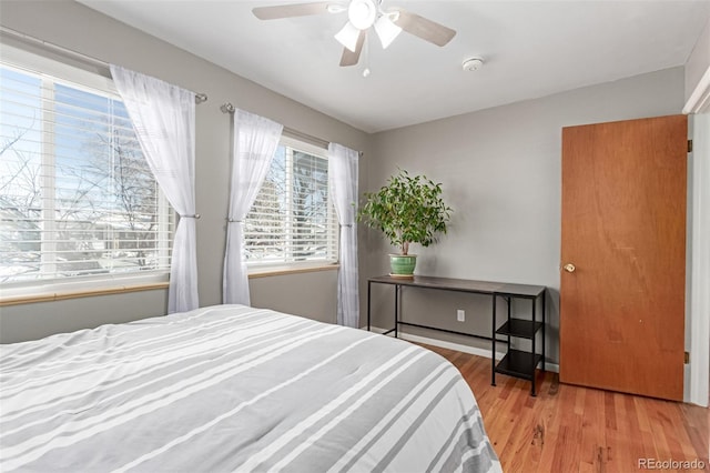 bedroom with ceiling fan and wood finished floors