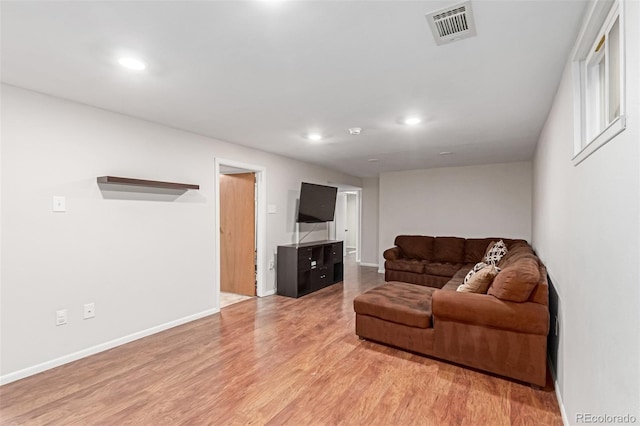 living area featuring light wood-type flooring, baseboards, visible vents, and recessed lighting