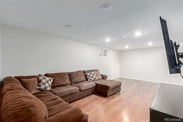 living area with baseboards, light wood-style flooring, and recessed lighting