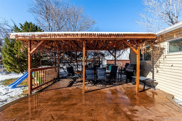 view of patio with outdoor dining space and grilling area