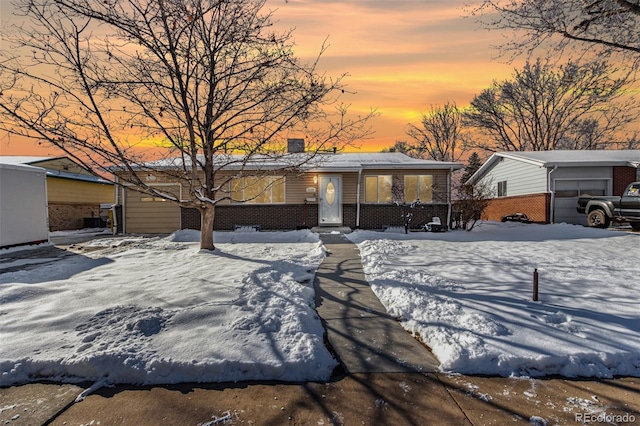 mid-century home featuring an outbuilding and brick siding