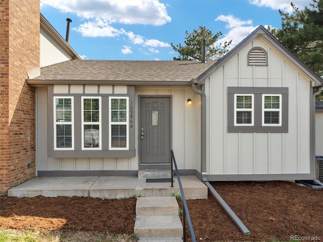16986 E Piedmont Dr Unit A, Aurora, CO 80015 - doorway to property with board and batten siding and roof with shingles