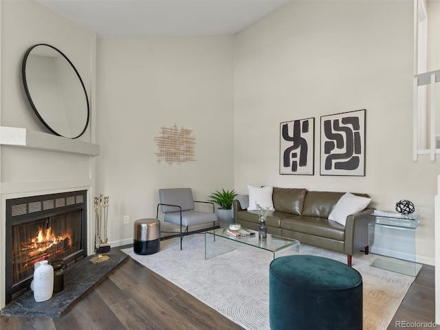 16986 E Piedmont Dr Unit A, Aurora, CO 80015 - living area featuring wood finished floors, a warm lit fireplace, and a high ceiling