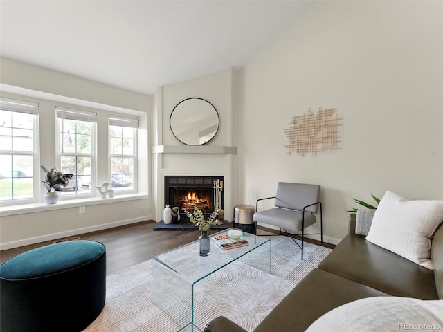 16986 E Piedmont Dr Unit A, Aurora, CO 80015 - living area featuring wood finished floors, a lit fireplace, and lofted ceiling