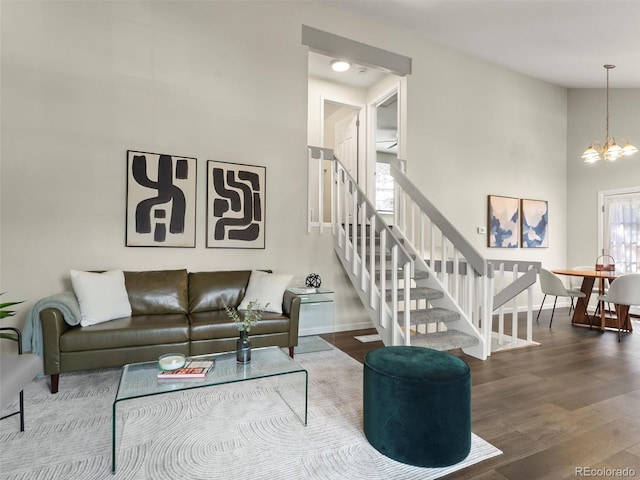 16986 E Piedmont Dr Unit A, Aurora, CO 80015 - living room featuring wood finished floors, stairway, a chandelier, and a high ceiling