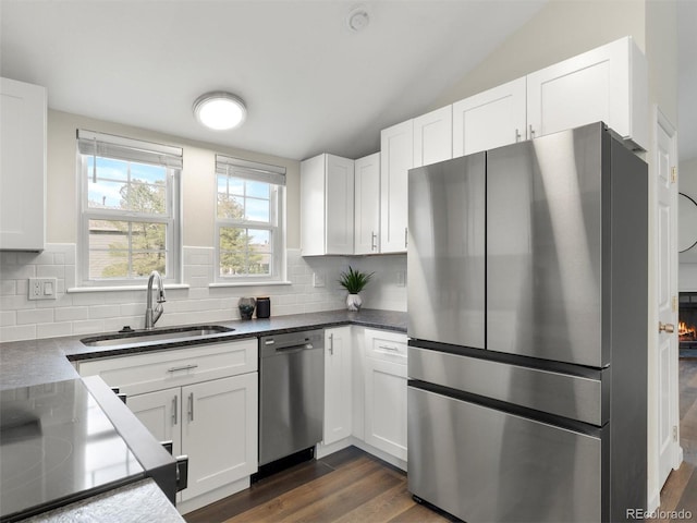 16986 E Piedmont Dr Unit A, Aurora, CO 80015 - kitchen with appliances with stainless steel finishes, tasteful backsplash, white cabinetry, and lofted ceiling