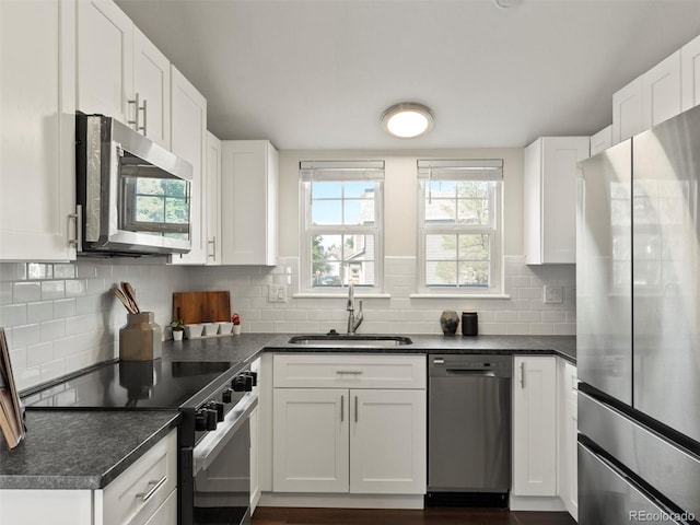 16986 E Piedmont Dr Unit A, Aurora, CO 80015 - kitchen featuring appliances with stainless steel finishes, white cabinets, backsplash, and dark countertops