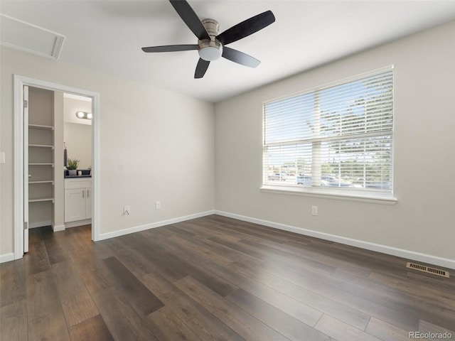 16986 E Piedmont Dr Unit A, Aurora, CO 80015 - unfurnished bedroom featuring a walk in closet, dark wood-style flooring, and a ceiling fan